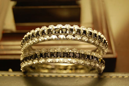 PAIR OF BLACK & ZIRCON BANGLES IN SILVER BASE