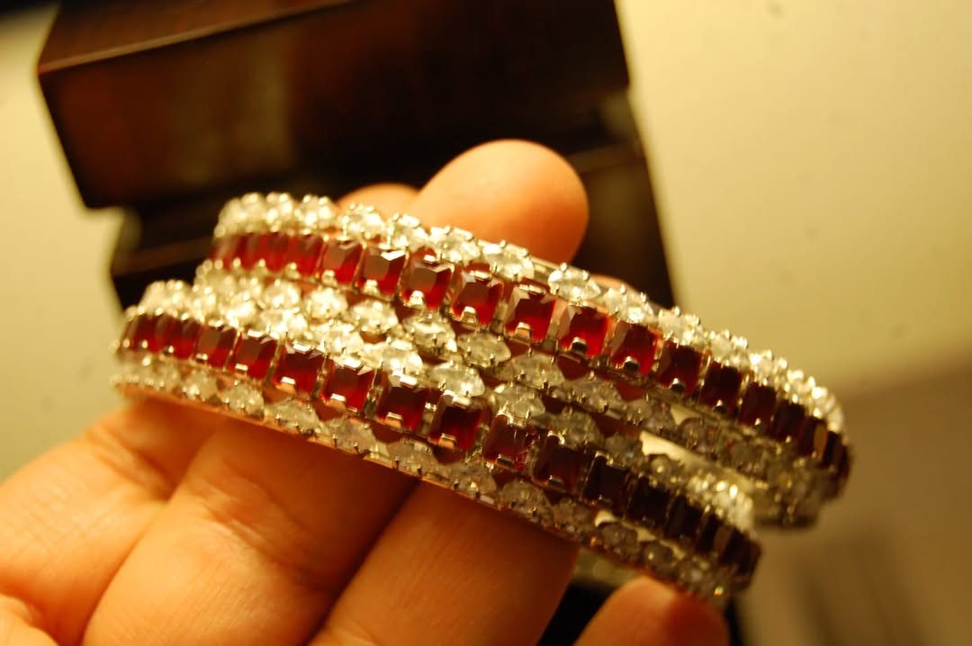 PAIR OF RED & ZIRCON BANGLES IN SILVER BASE